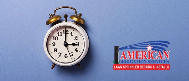 Alarm clock on a blue background with the American Irrigation Services logo